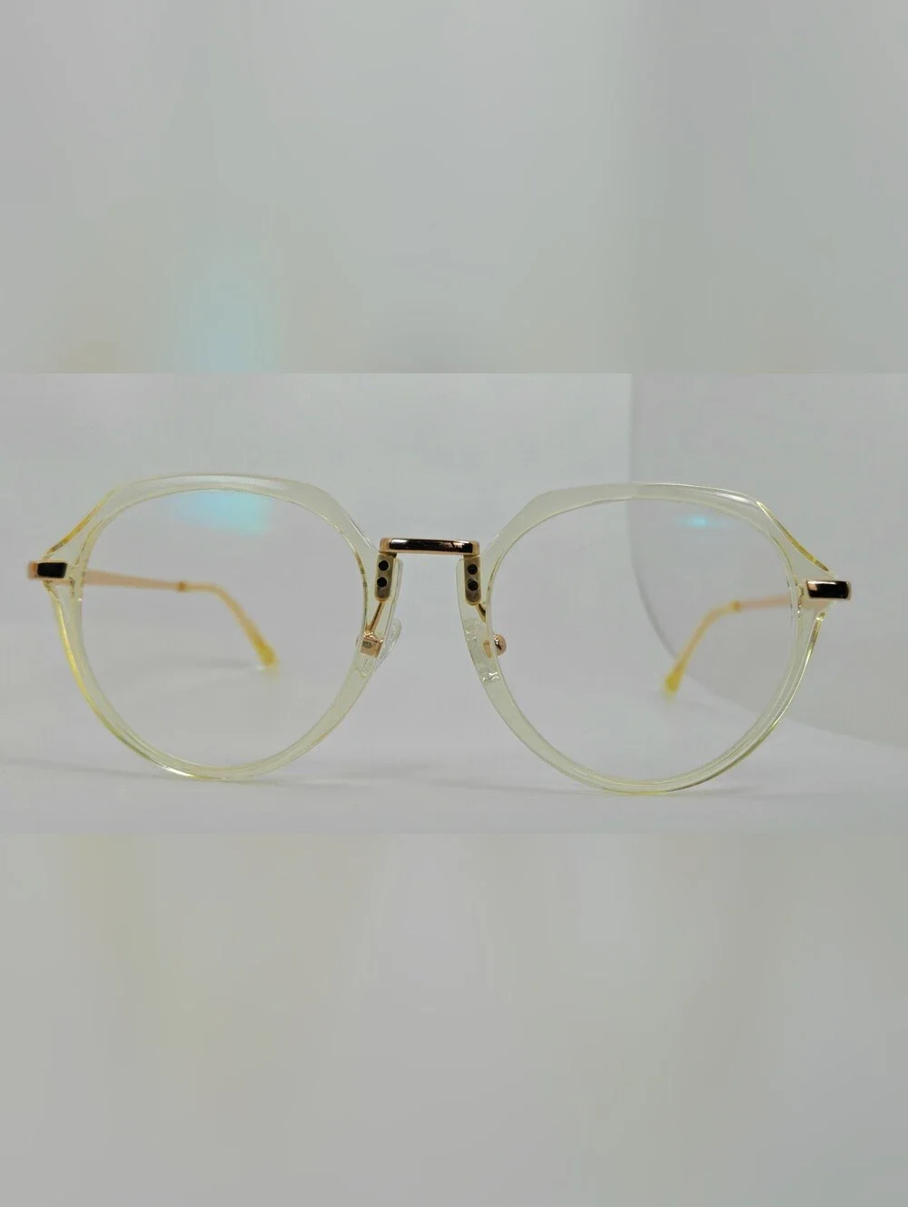 Tamara. Clear Round Frame Glasses. All Gold Accents are Metal.